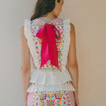 colourful embroidered top and skirt with bright pink bow