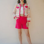 bright pink embroidered jacket and pink shorts outfit