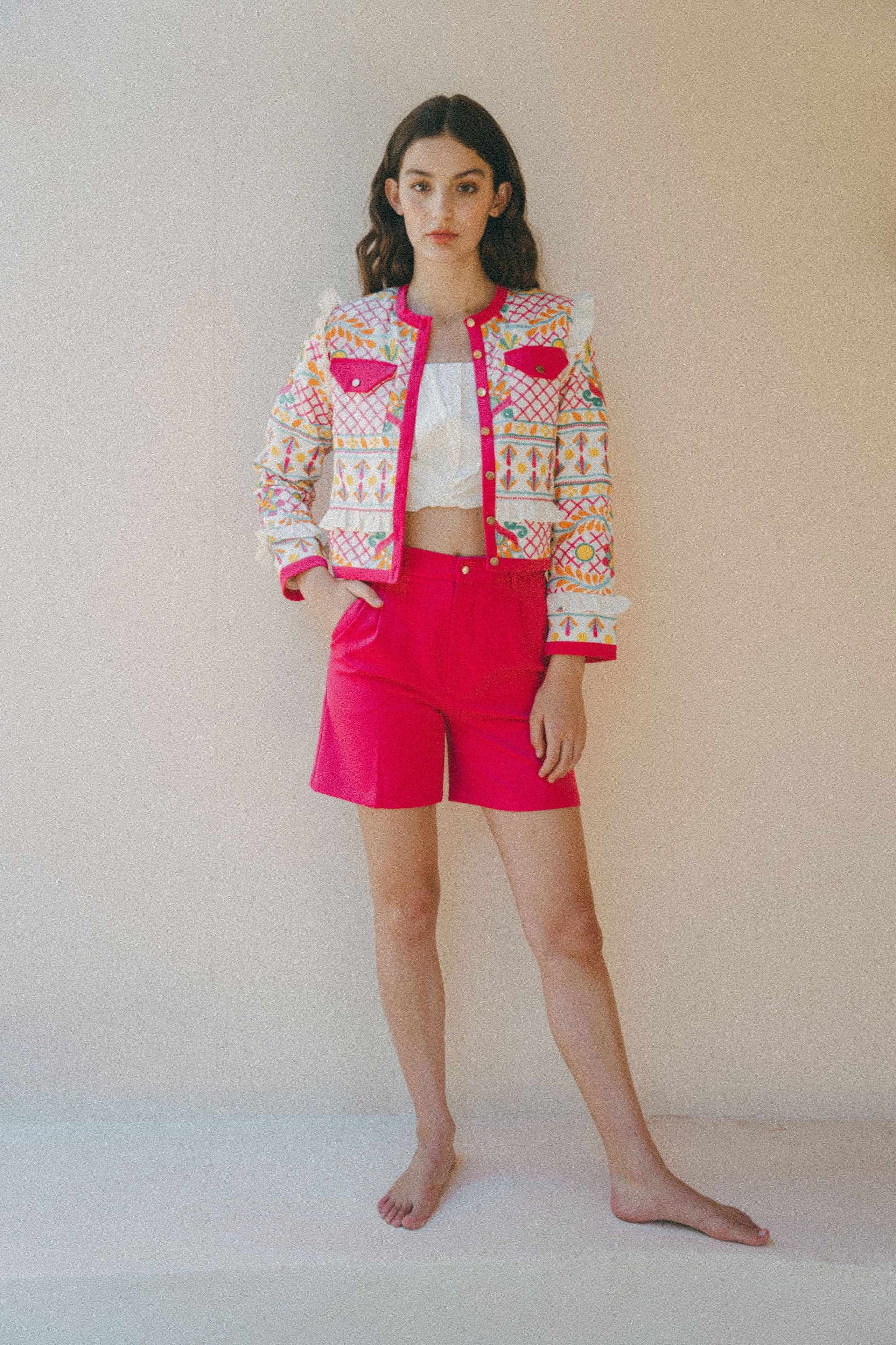 bright pink embroidered jacket and pink shorts outfit