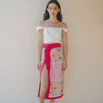 white crop top with colourful embroidered sarong with pink border