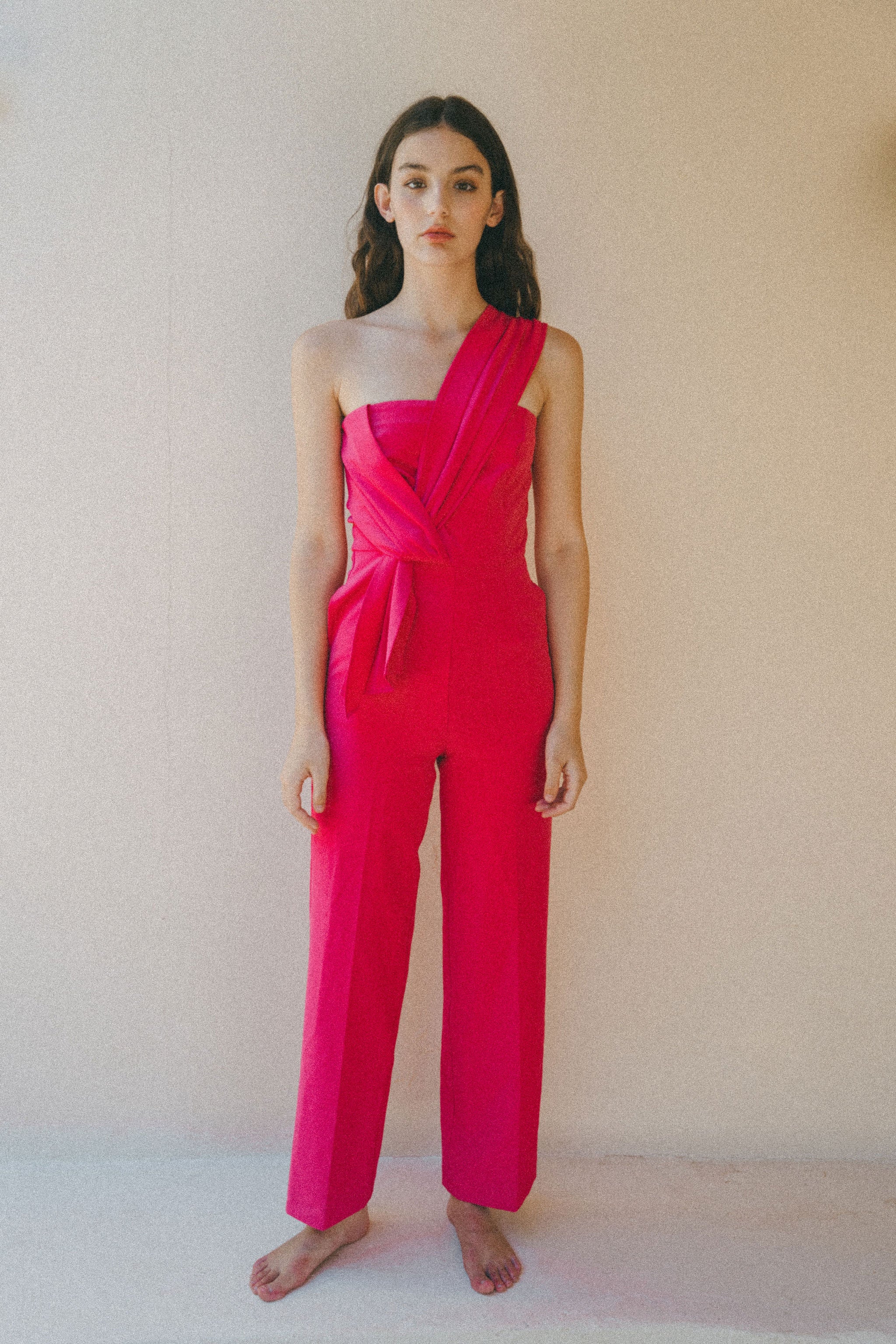 bright pink jumpsuit with pleat detail