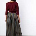 Back view of maroon pleated shirt and printed maxi skirt
