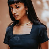 The Kōr Ribbed Knit Organic Cotton Short Sleeve Top in Black