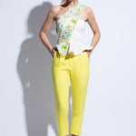 Model wears the colourful embroidered one shoulder top with tailored yellow trousers