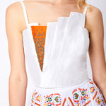 Close up on silk pleated stop and maxi skirt embellishment detail