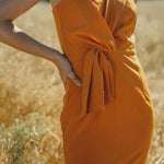 orange fitted dress with pleating details