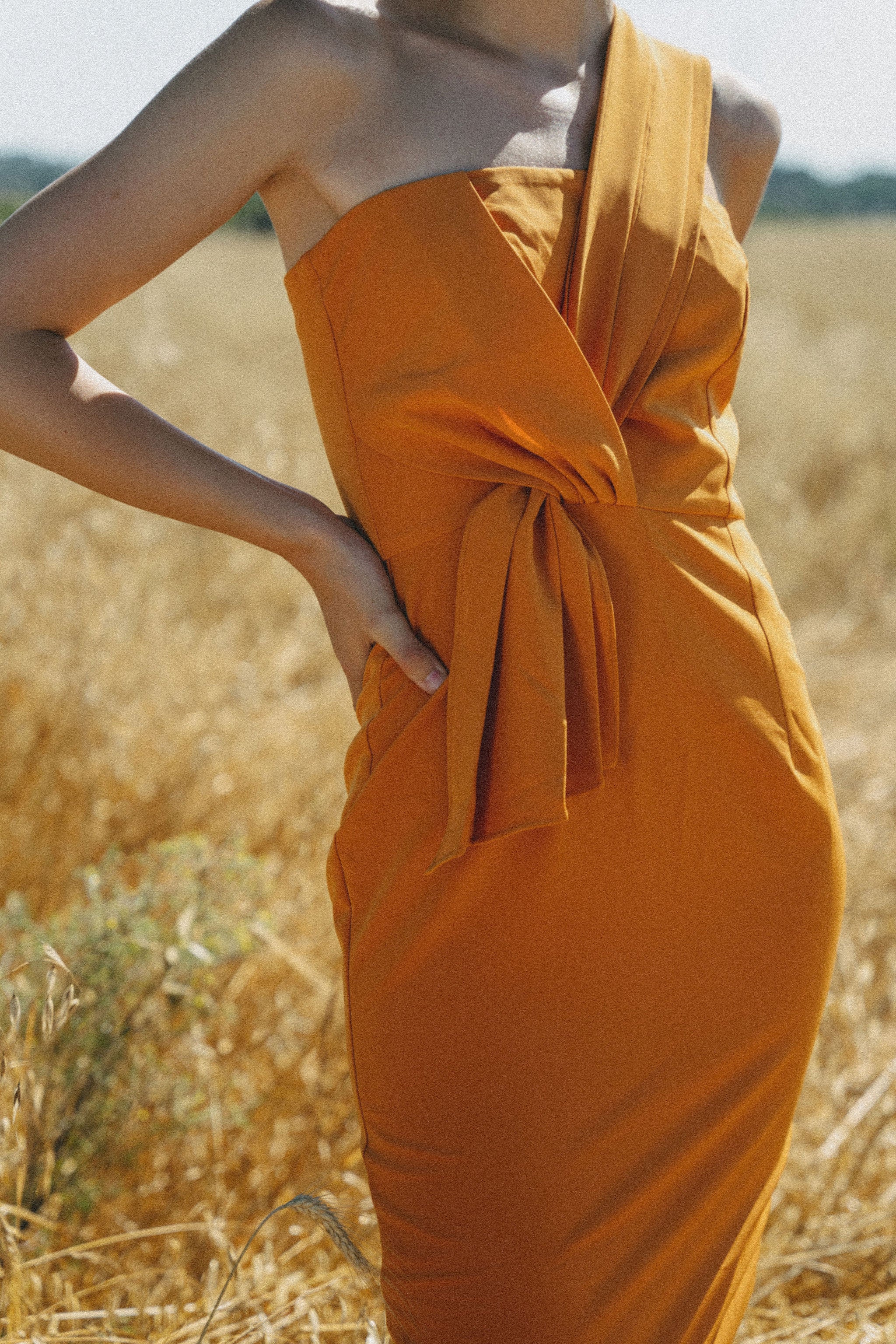 orange fitted dress with pleating details