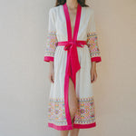 cream coverup with colourful embroidery and pink border