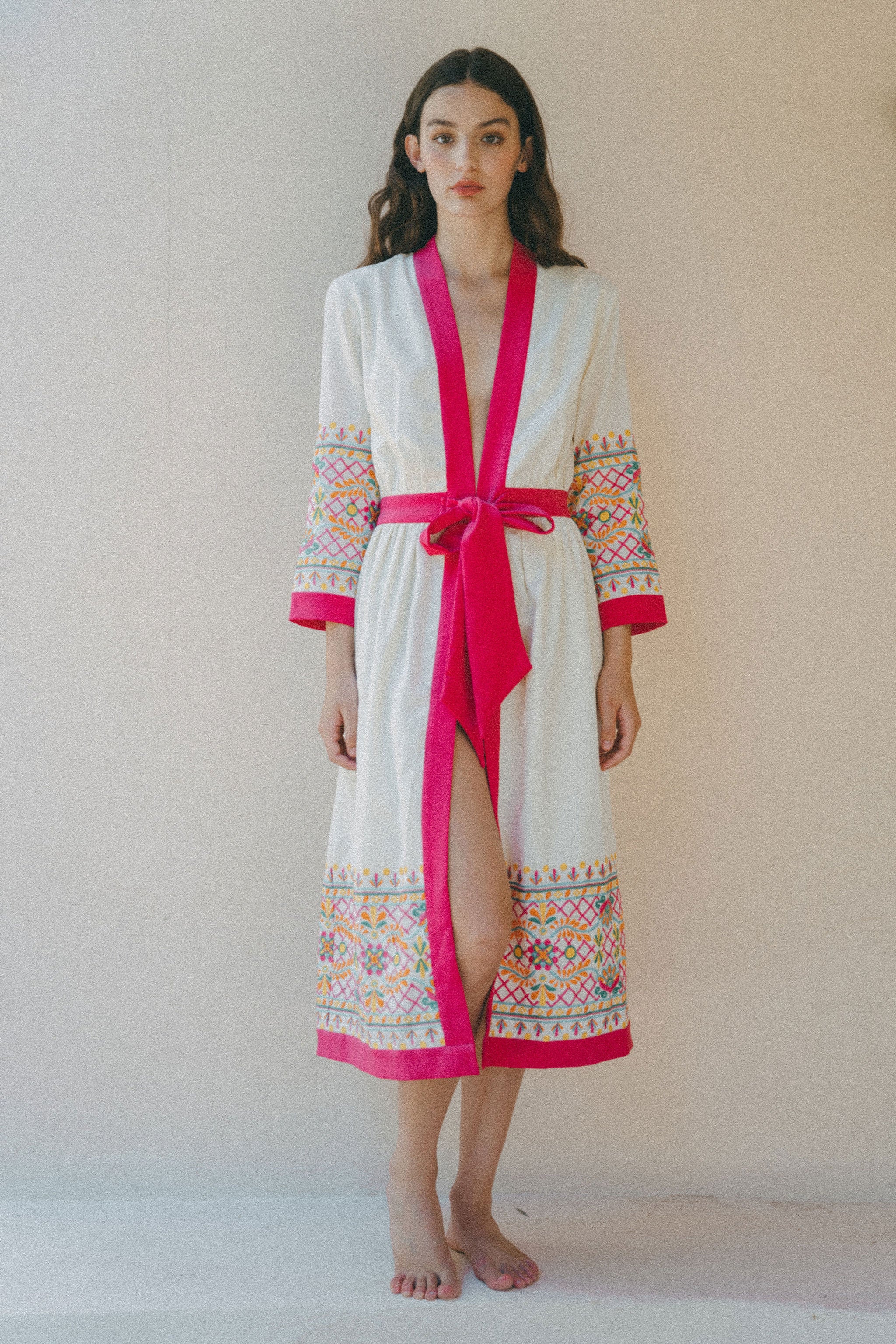 cream coverup with colourful embroidery and pink border