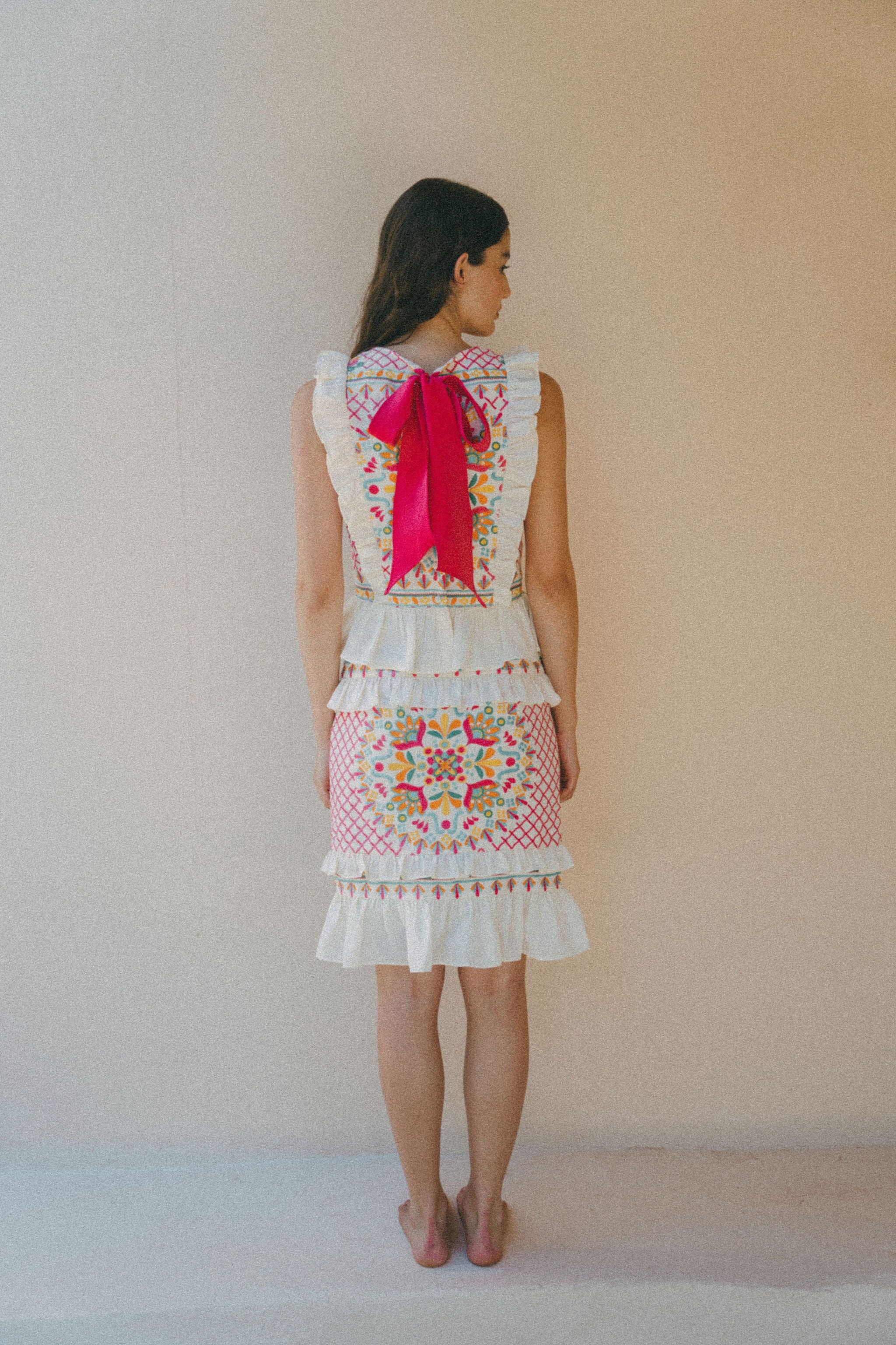 back of embroidered frill top and skirt with pink bow