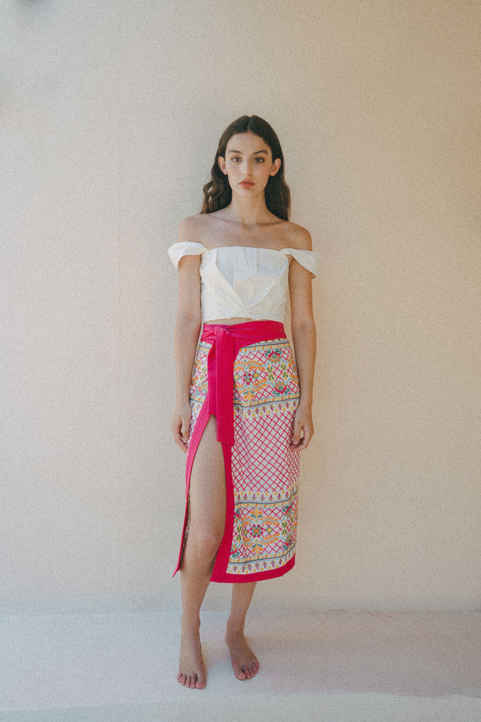 white crop top with colourful embroidered sarong with pink border