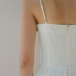 close up of back white dress with thin strap