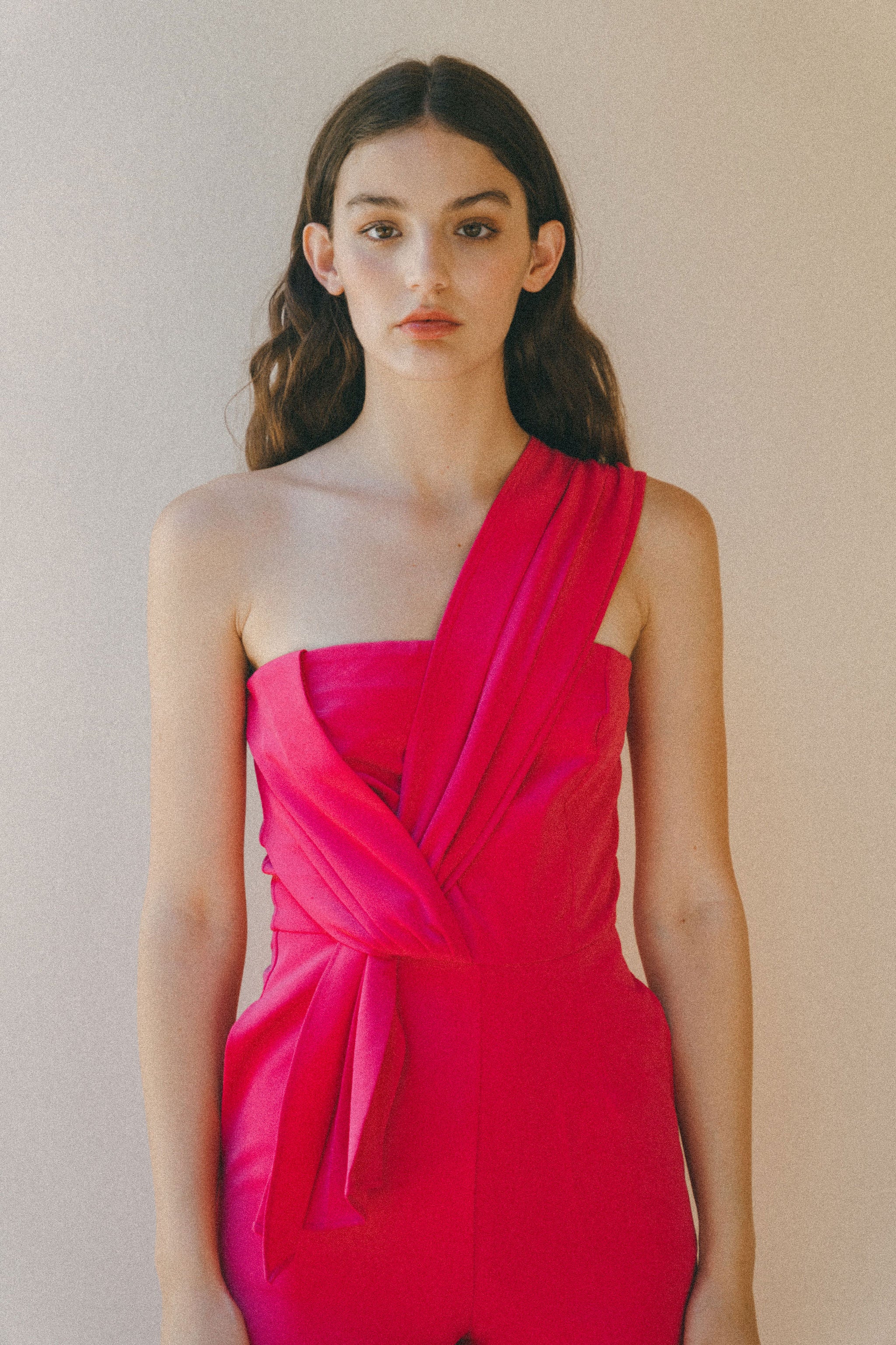 bright pink jumpsuit, pleat details