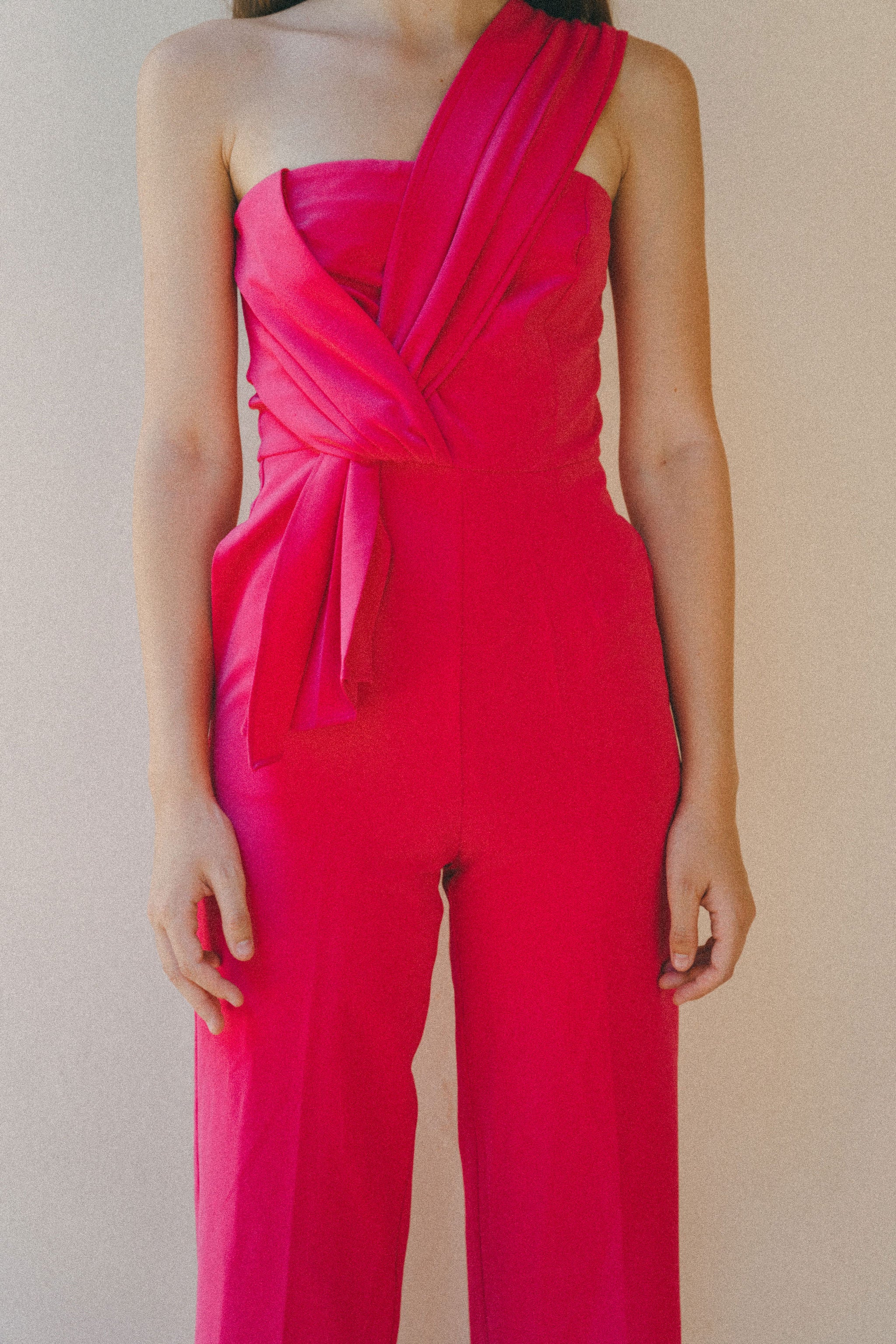 bright pink jumpsuit with pleating detail