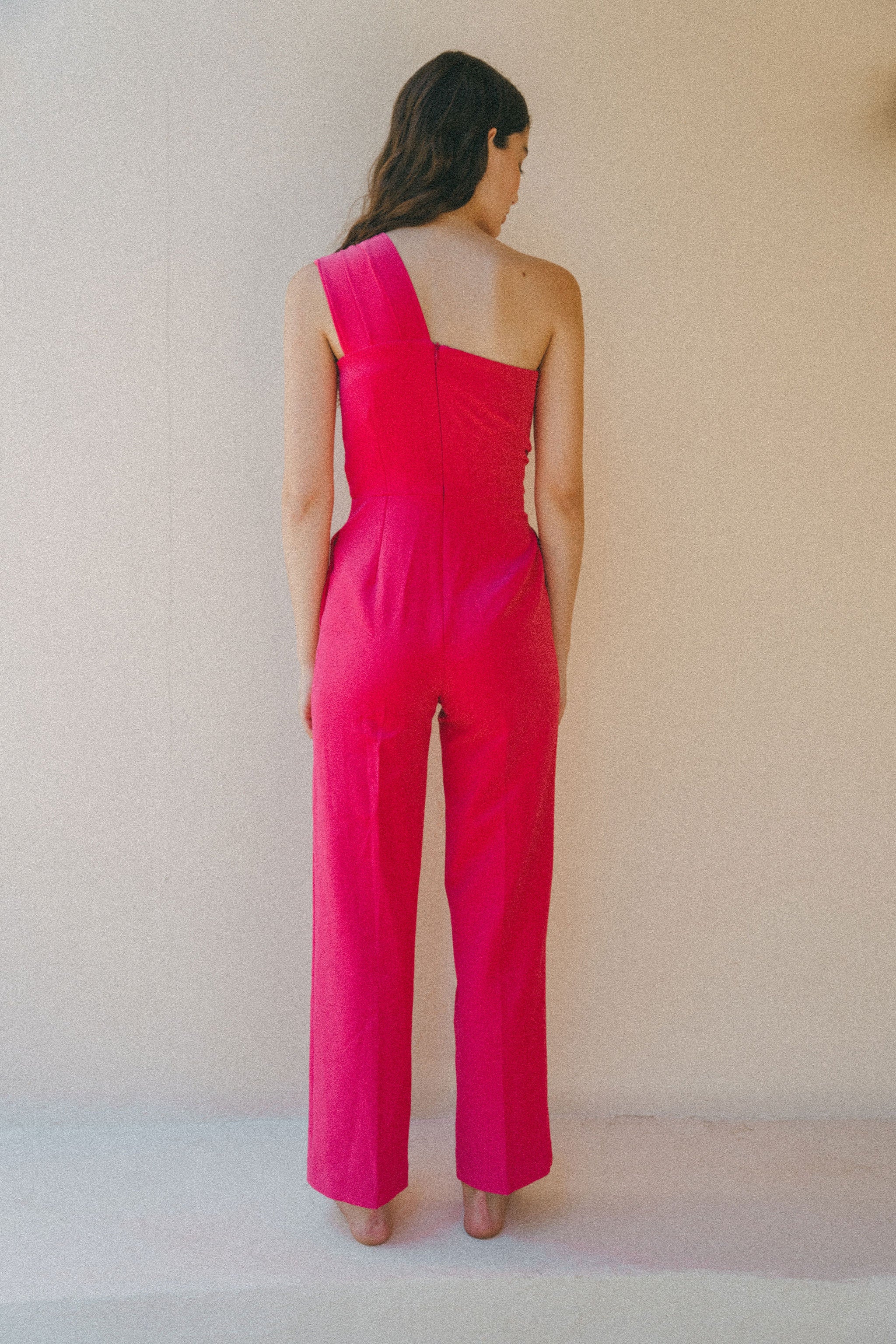 back of bright pink jumpsuit