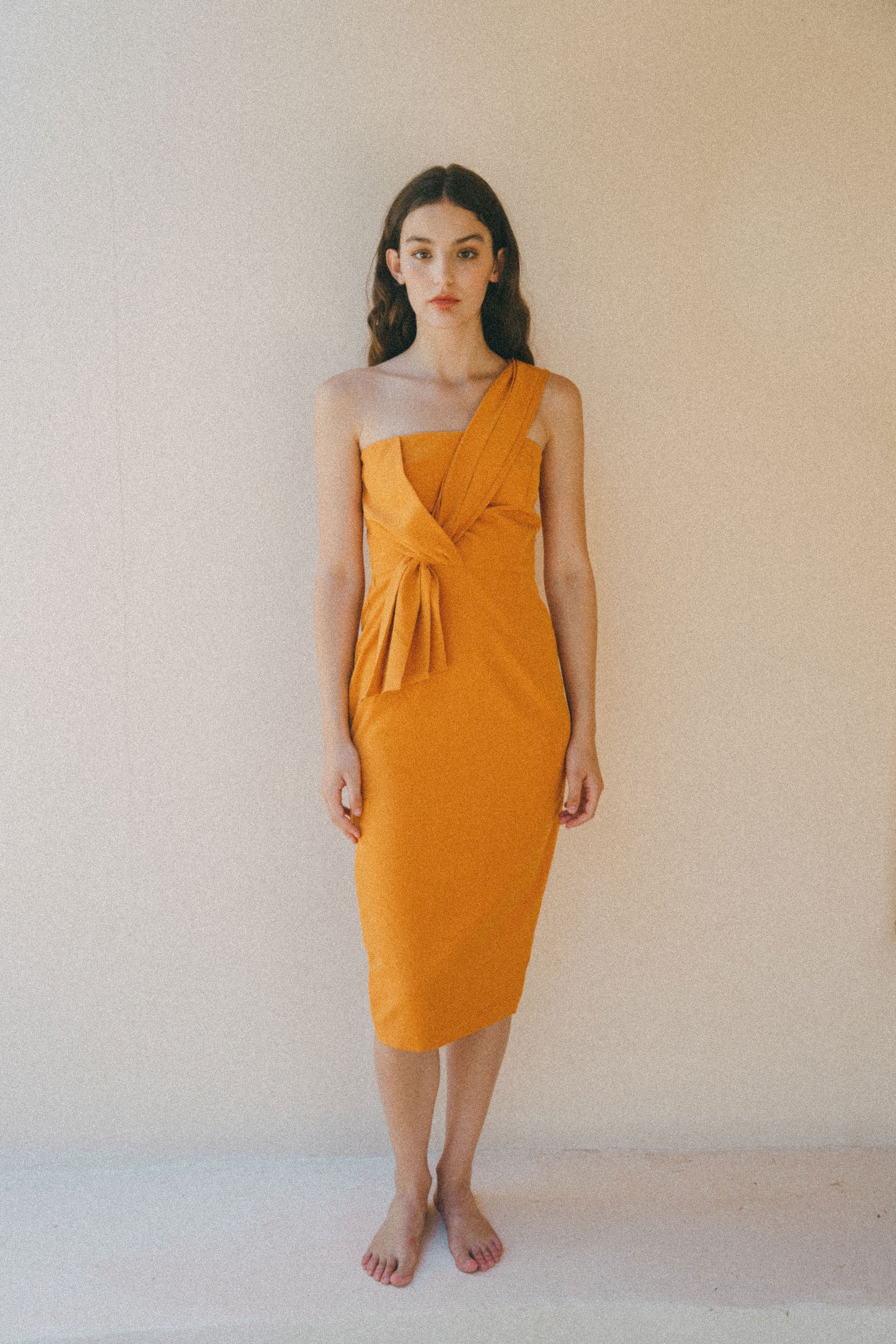 orange fitted dress with pleating details