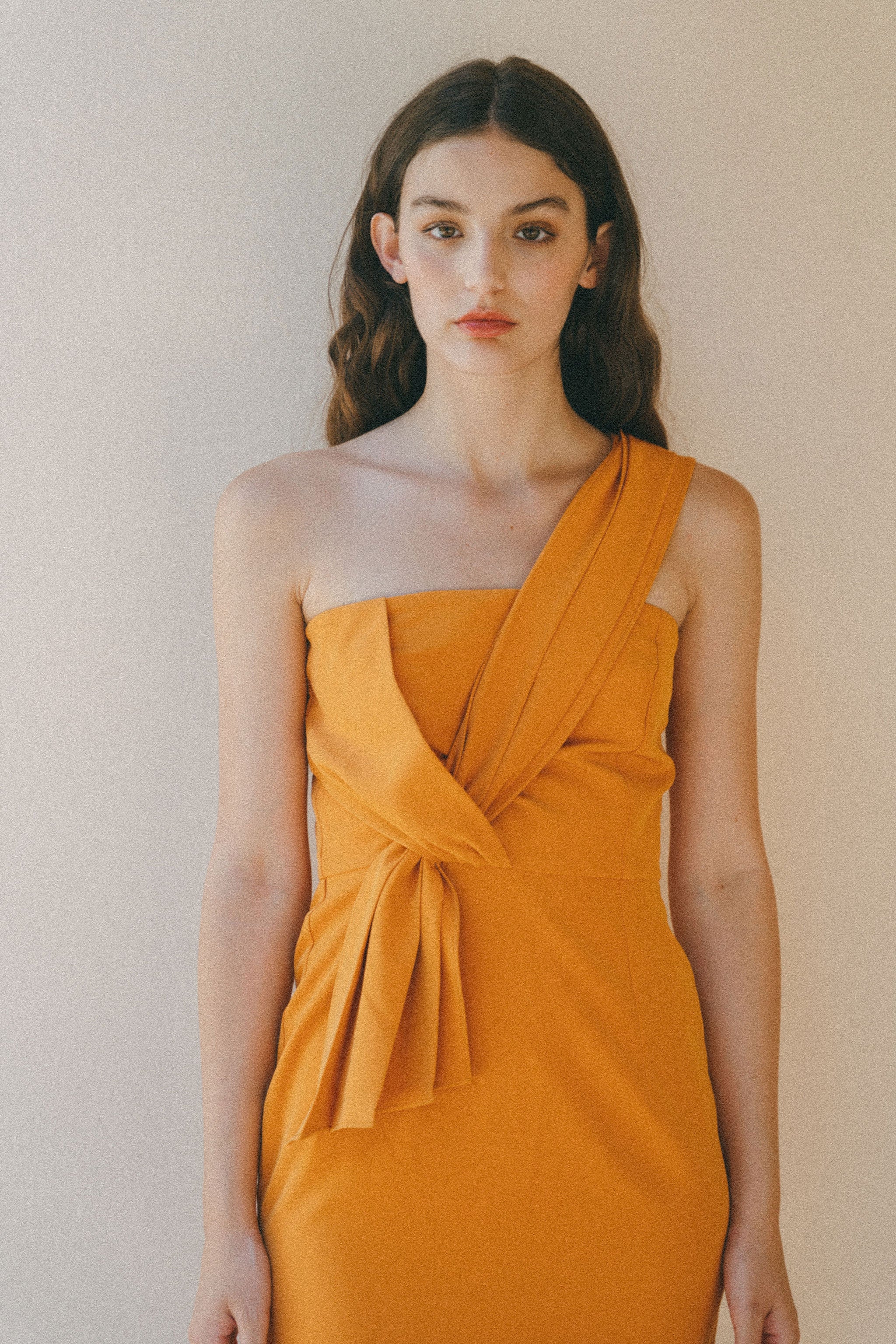 orange fitted dress with pleating details