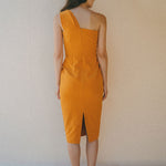 back of orange fitted dress with pleating details