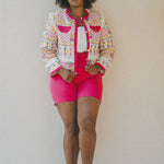 bright pink shorts and embroidered jacket