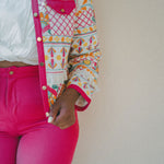 colourful embroidered jacket with pink border and pink shorts