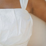 details of white pleated crop top strap