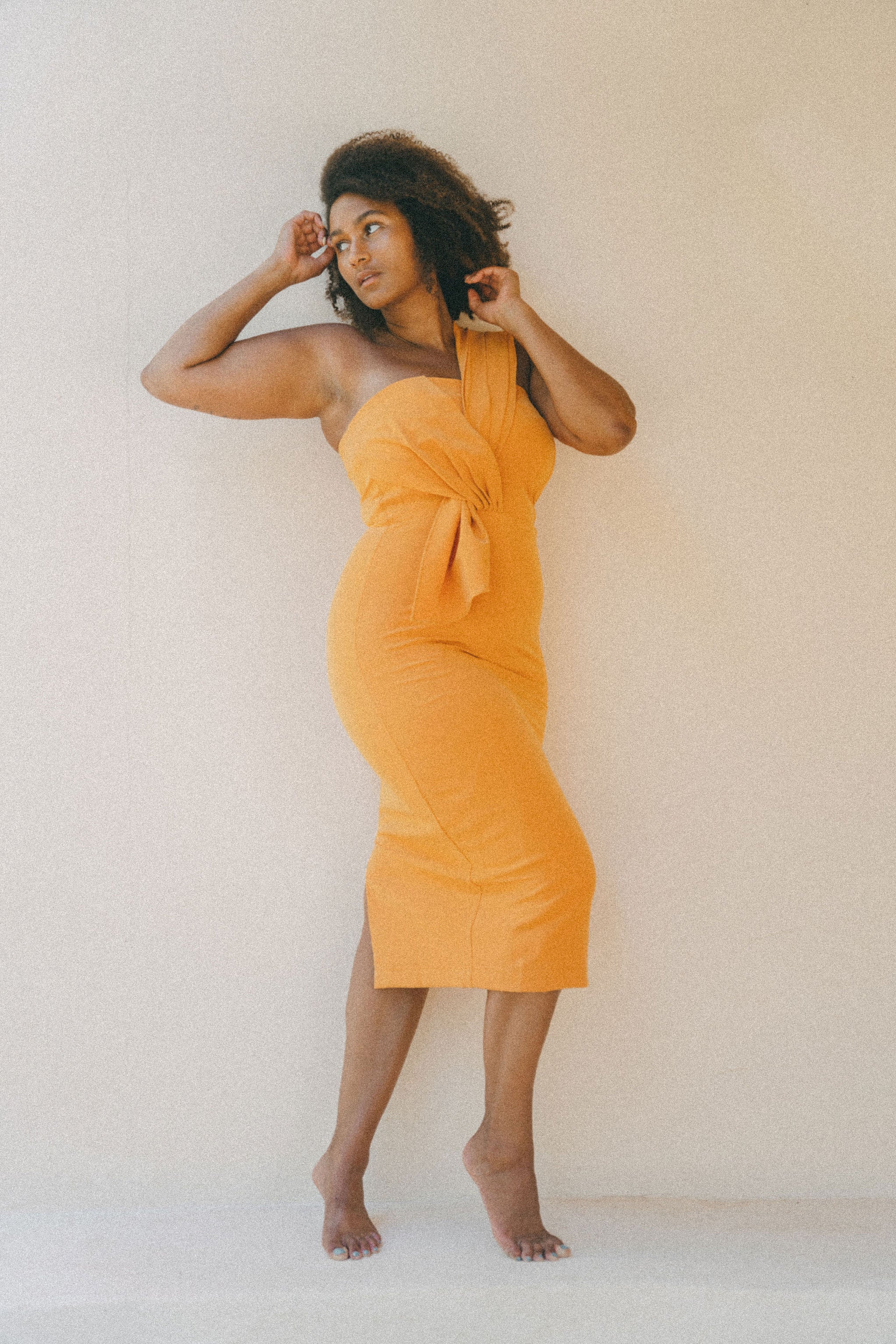 orange fitted dress with pleating details