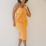 orange fitted dress with pleating details