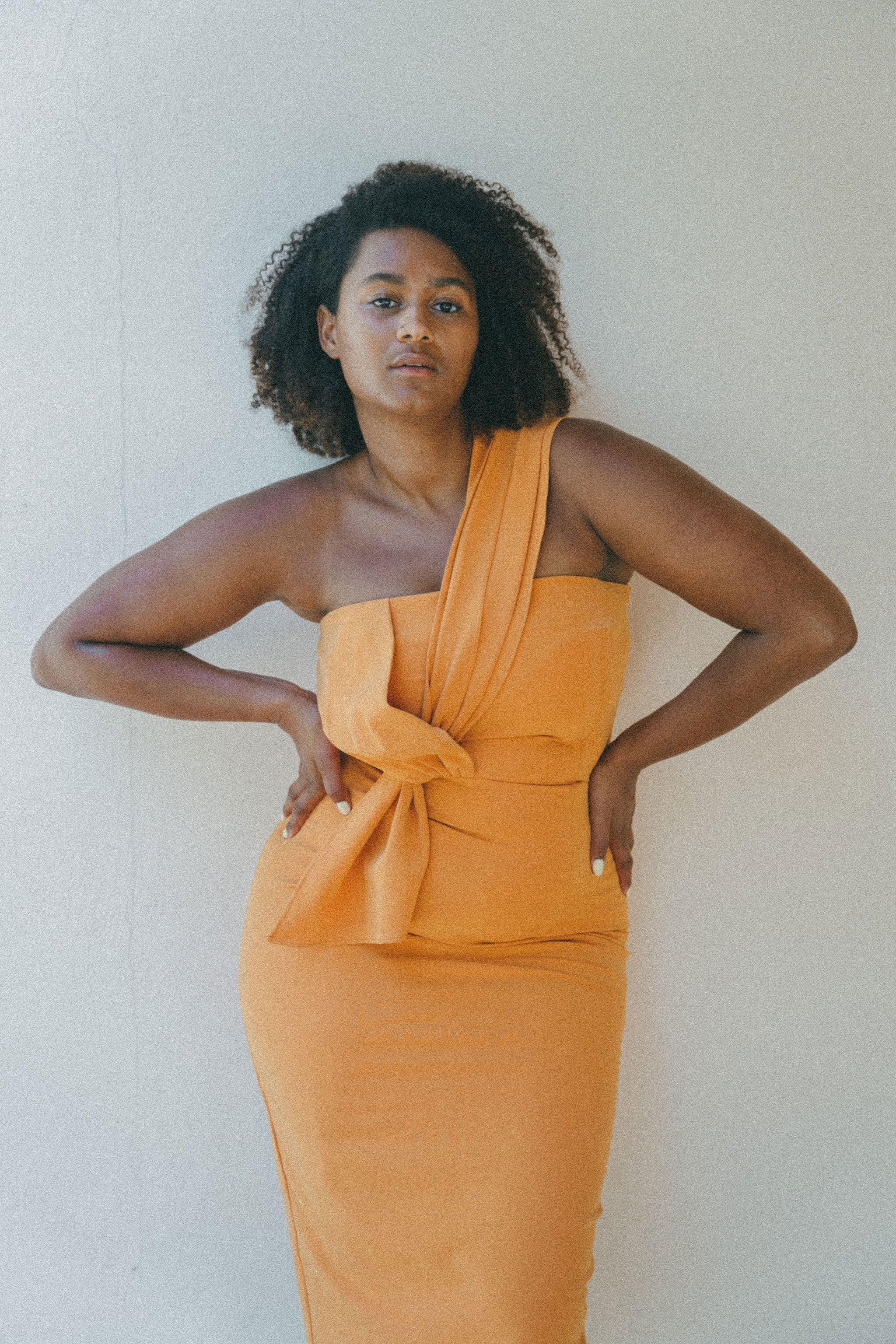 orange fitted dress with pleating details