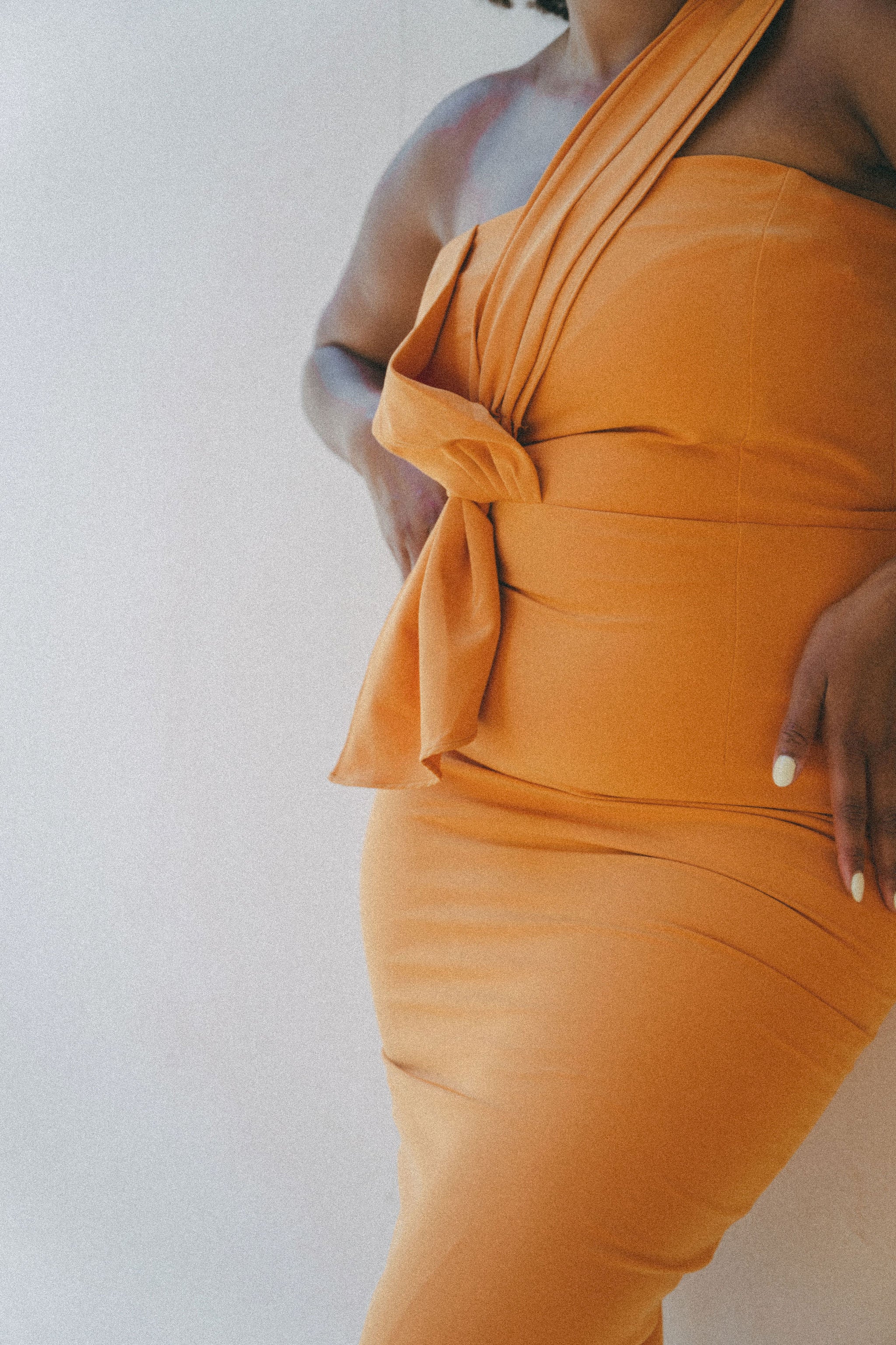 orange fitted dress with pleating details