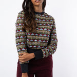 Model wears embroidered and beaded tulle jumper with maroon trousers