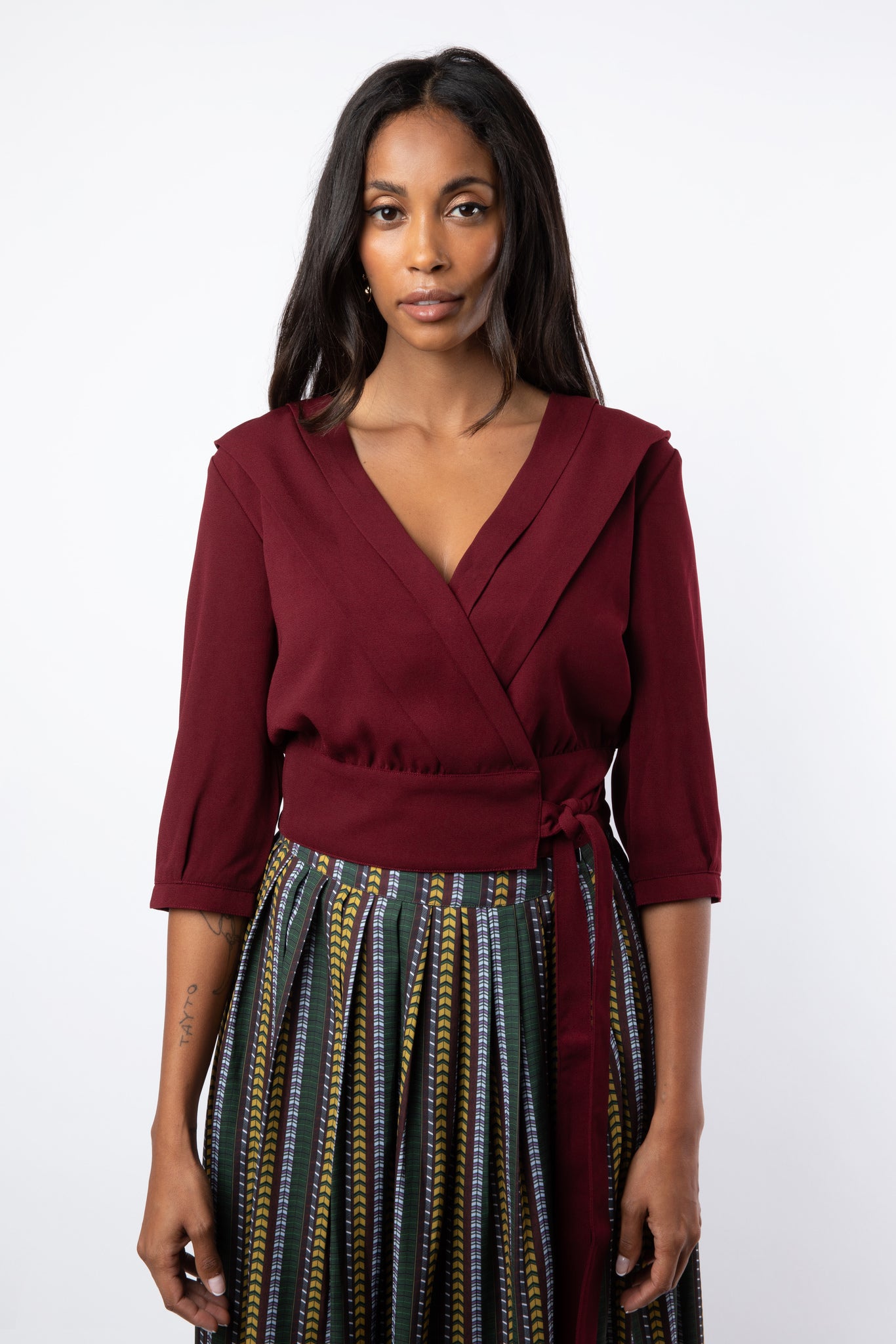 Maroon pleated wrap shirt tied with printed skirt