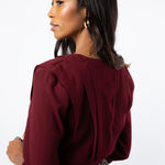 Back view close up of pleated maroon shirt details