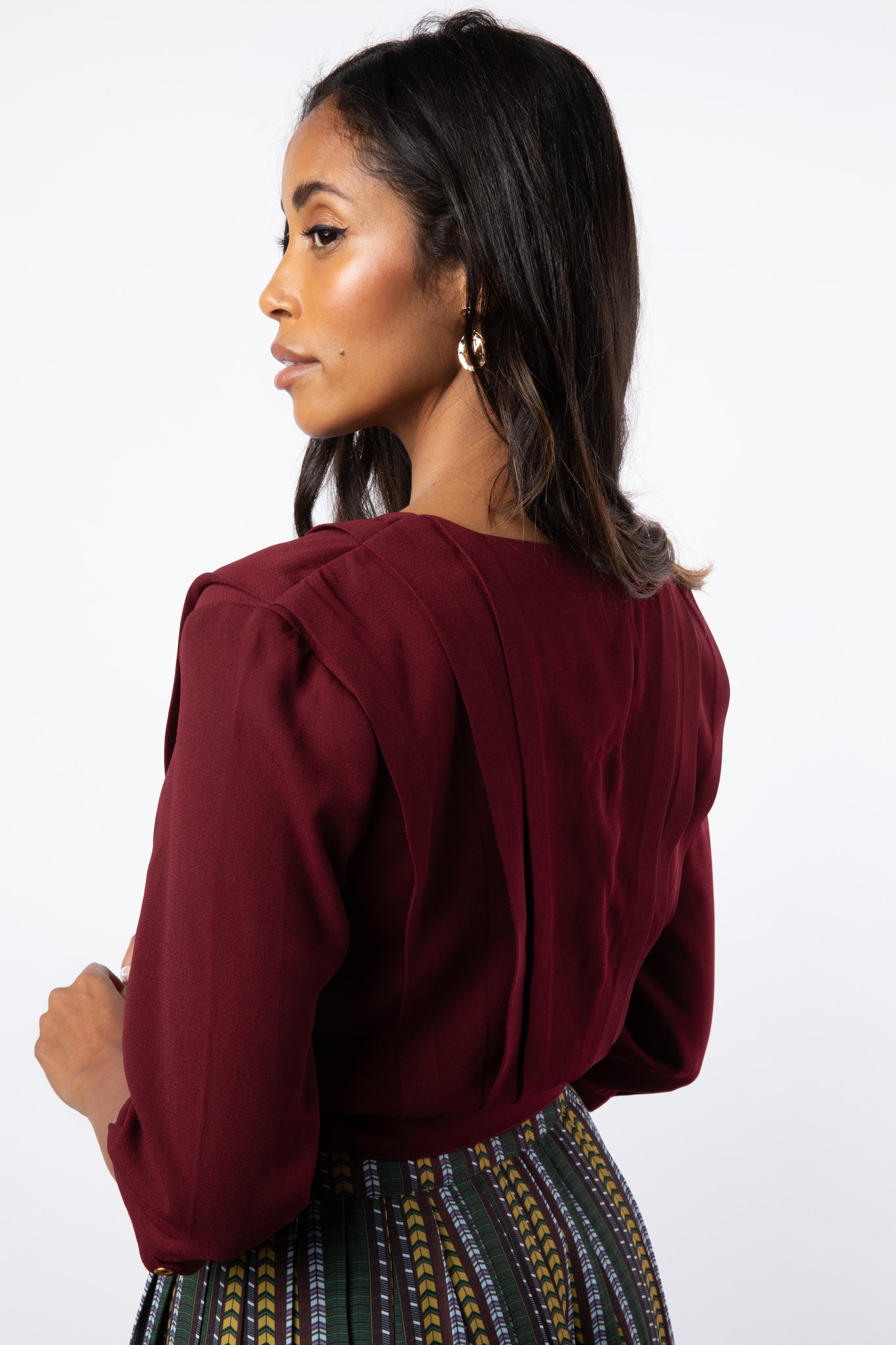 Back view close up of pleated maroon shirt details