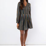 Model wears short geometric printed dress with sleeves