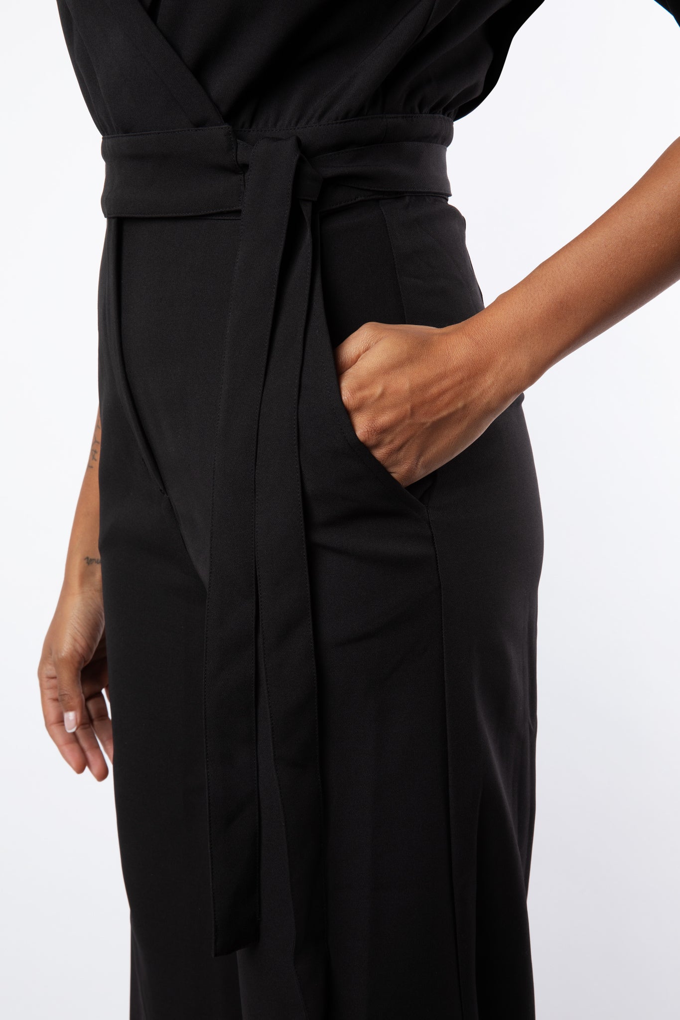 Close up pocket detail of black jumpsuit
