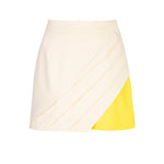 Cream pleated long panel with yellow shorts underneath, pocket and waistband