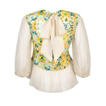 Back view of bright and colourful embroidered top with bow detail